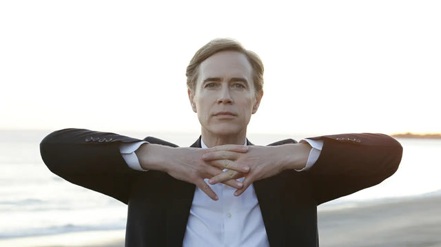 Black suit jacket with white shirt and hand gesture, cultivating integrity in Christian life coaching