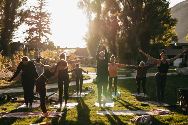 Women developing healthy habits via outdoor yoga for business success