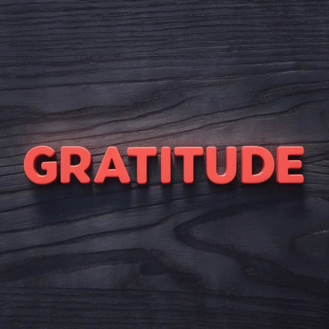 Woman cultivating gratitude in hustle culture, holding grateful sign