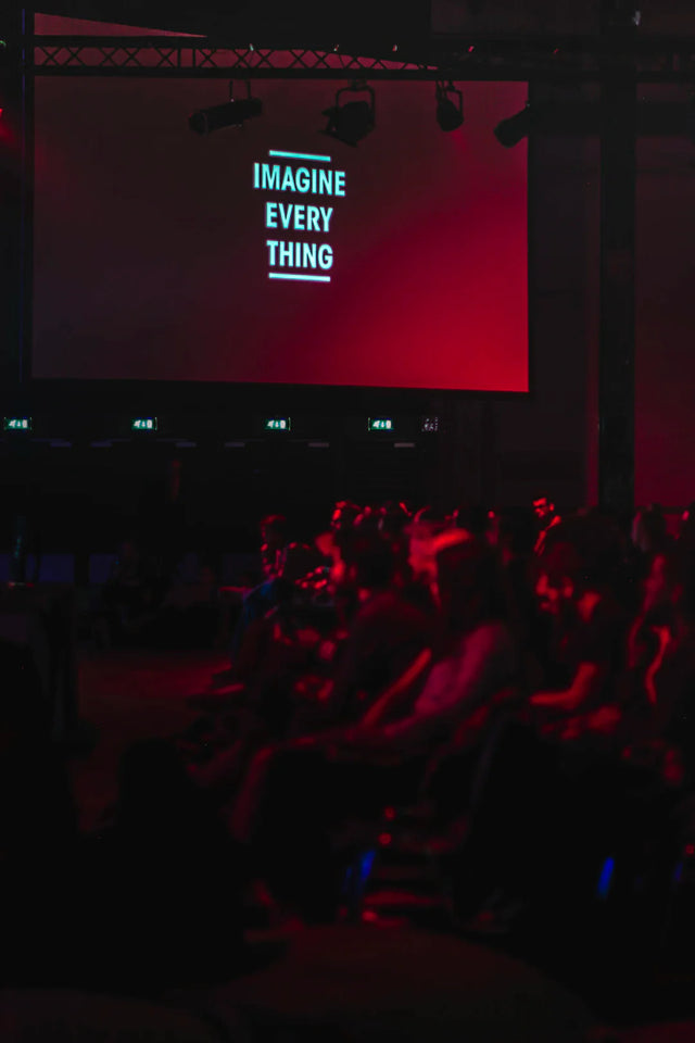 Glowing cyan text reading IMAGINE EVERYTHING on screen, symbolizing a strong alumni network for continuous engagement