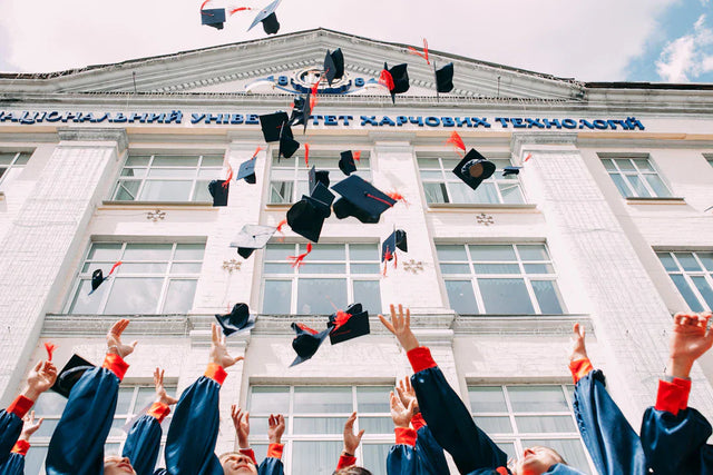 Graduation caps tossed in the air symbolizing trust school leadership and strengthening bonds