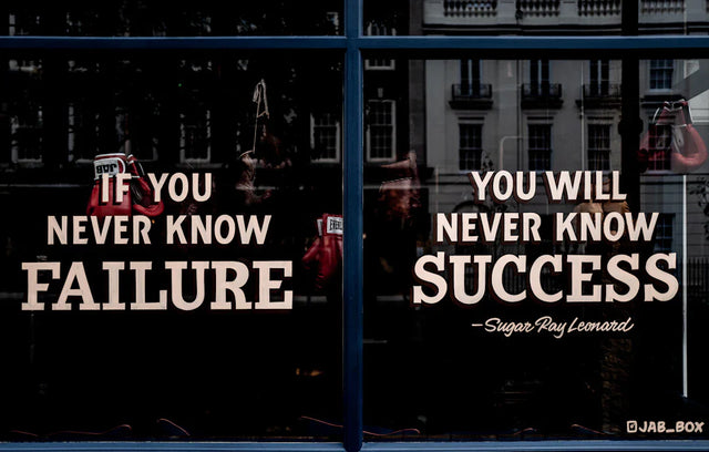 Window display with an inspirational quote promoting celebrating small wins and growth mindset
