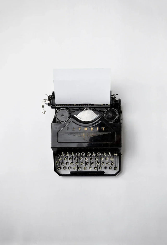 Vintage black typewriter with blank paper symbolizing crafting a unique brand story for social media