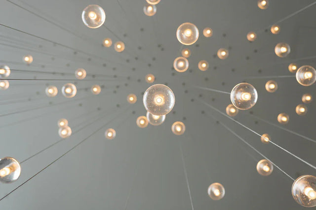 Illuminated spherical light bulbs symbolizing creative problem solving in workplace innovation