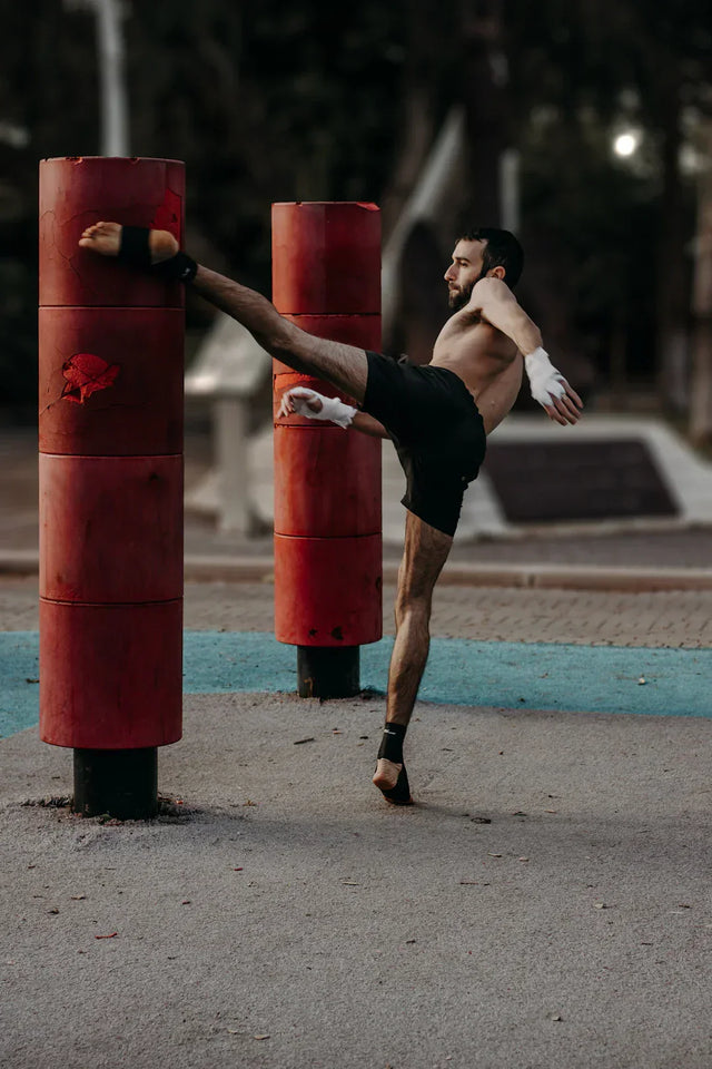 Red cylindrical padded training dummies with textured grip for personal development training