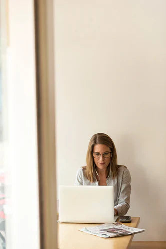 Person working on a laptop at a desk demonstrating effective accountability for continuous improvement