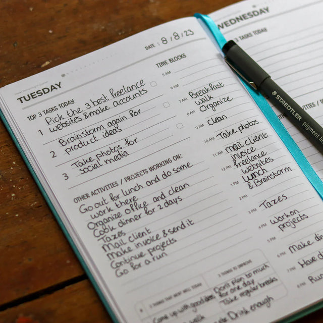 Open daily planner with handwritten schedule demonstrating effective time management for professional growth