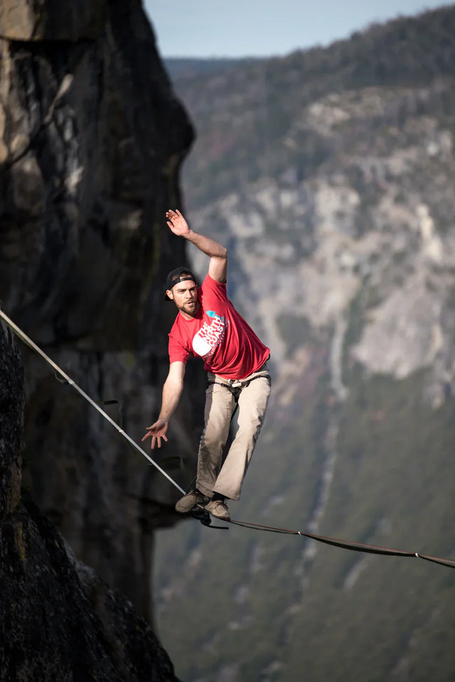 Man highlining between cliffs symbolizing Avodah Dynamics’ long-term vision in brand storytelling