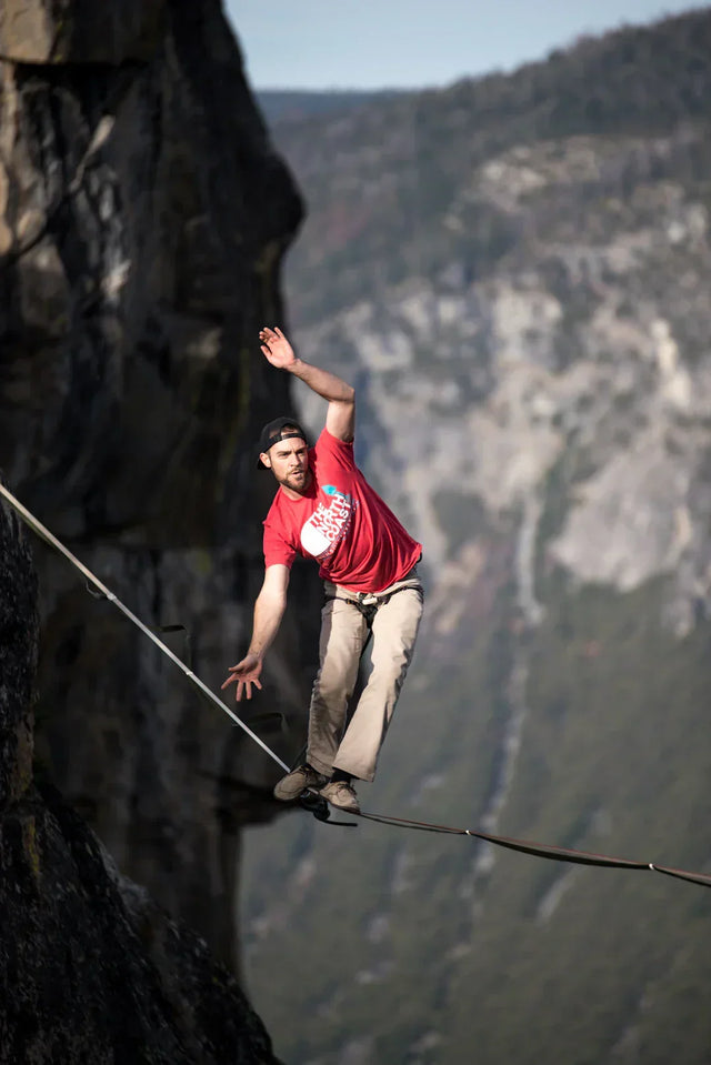 Man highlining between cliffs symbolizing Avodah Dynamics’ long-term vision in brand storytelling