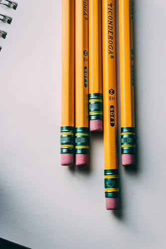 Yellow wooden pencils with pink erasers and green bands for envisioning success in collaborative school vision