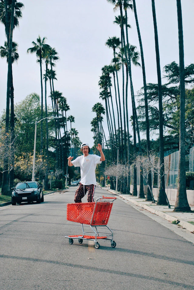 Man standing in a red shopping cart illustrating growth mindset and spiritual leadership