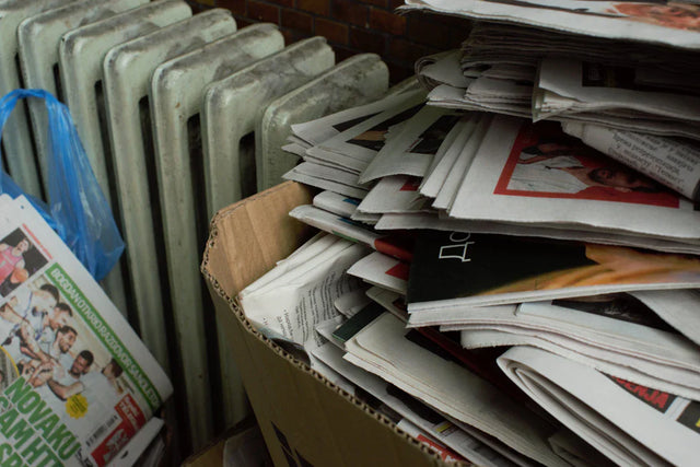 Overstuffed cardboard box of newspapers illustrating shaping school vision and enrollment strategies