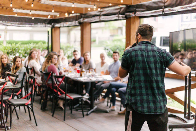 Man speaking to a group promoting building meaningful connections at Avodah Dynamics event