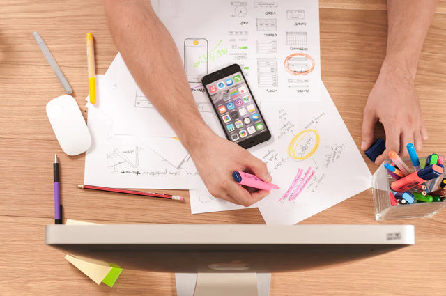 Smartphone on design sketches illustrating innovative marketing strategies for purpose-driven brands