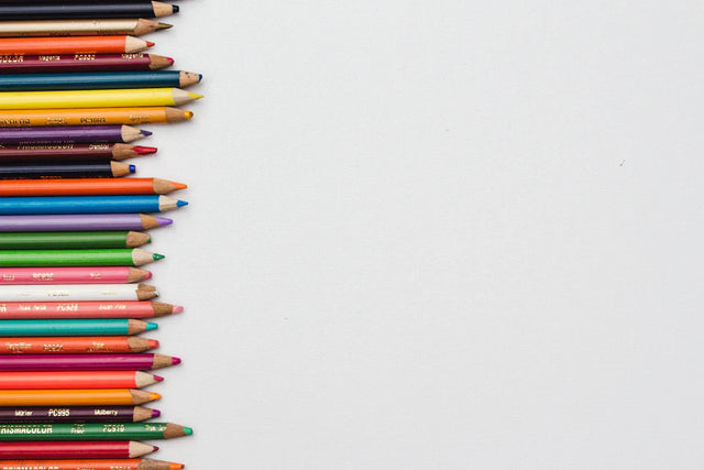 Colorful wooden pencils aligned on the left symbolize positive school culture and Avodah Dynamics