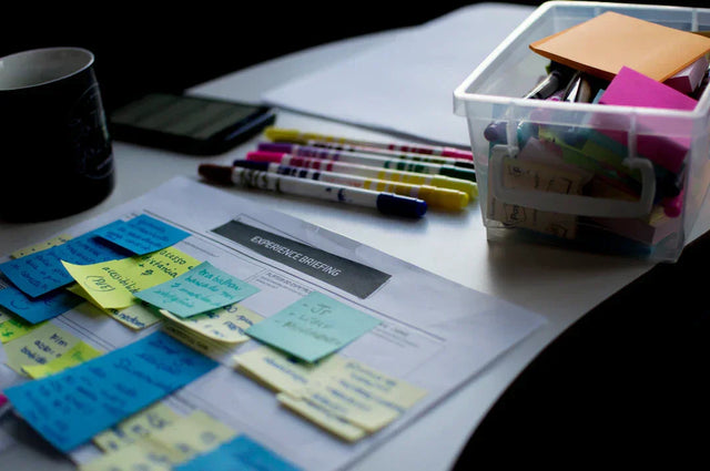 Document with colorful sticky notes and markers on purpose-driven initiatives and KPIs