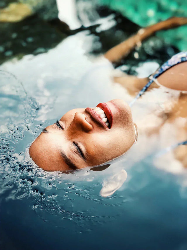 Person floating face-up in clear water symbolizing recognizing limitations for self-reflection