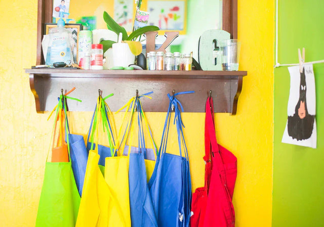 Colorful aprons hanging on hooks representing showcasing school values at open house events
