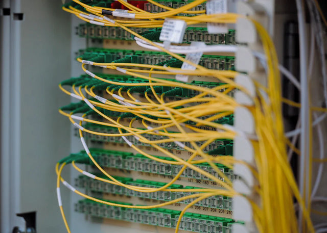 Fiber optic patch panel with yellow cables supporting network for personal growth success