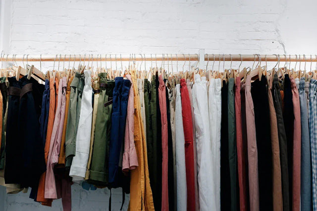 Clothes hanging on a rack showcasing sustainable activewear from Avodah Dynamics in a socially responsible setting