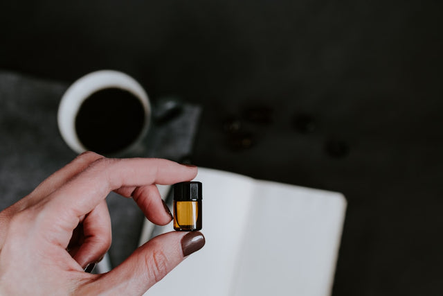 Hand holding a memory card with gold contacts, symbolizing wellness-oriented company culture.
