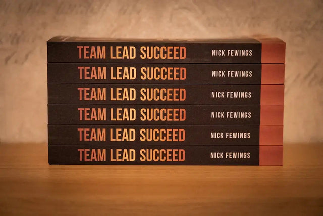 Stack of Team Lead Succeed books promoting purposeful team culture and open communication
