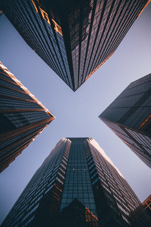 Four tall skyscrapers with reflective glass facades illustrating data analytics and consumer behavior insights