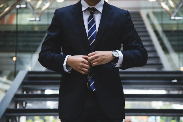 Dark blue suit with white shirt and striped tie illustrating core purpose in business strategies
