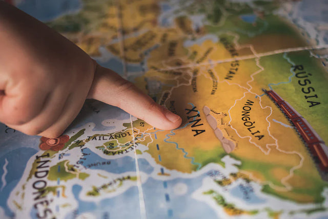 Hand pointing at Asia map highlighting opportunities for lifelong learning and professional development