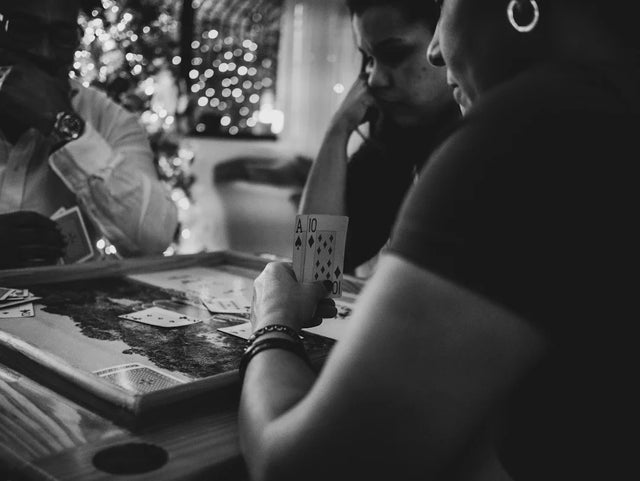 Playing cards in hand during a game illustrating taking calculated risks for success
