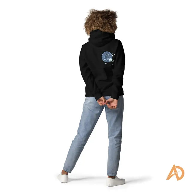 Black Galaxy Forward Hoodie with planet, stars, and forward text designPerson in a black hoodie with planet and stars design, wearing light blue jeans and white sneakers.
