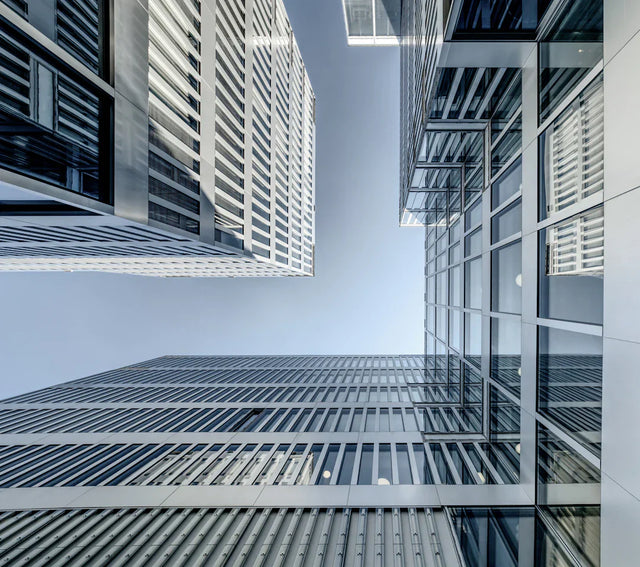Modern architectural skyscrapers with glass and metal facades reflecting technological advancements in the business landscape for customer satisfaction