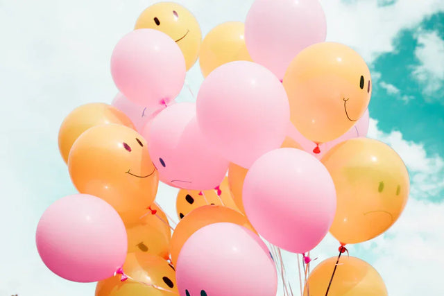 Balloons with facial expressions for collecting customer feedback on business goals
