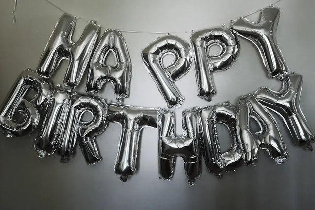 Silver Happy Birthday balloons celebrating milestones in purpose-driven journey