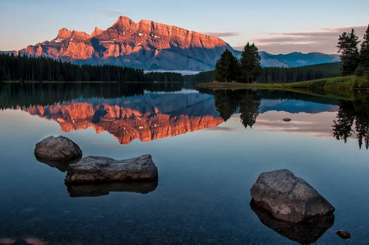 Mount Rundle reflects in Two Jack Lake at sunrise, embodying mindful meditation and self-care.