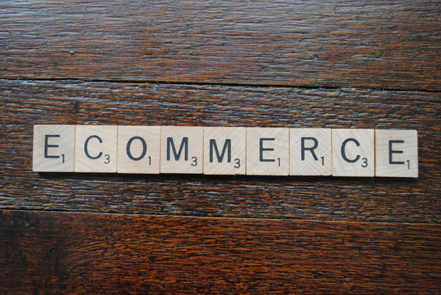 Scrabble tiles spelling ECOMMERCE representing continuous learning and growth mindset for long-term benefits