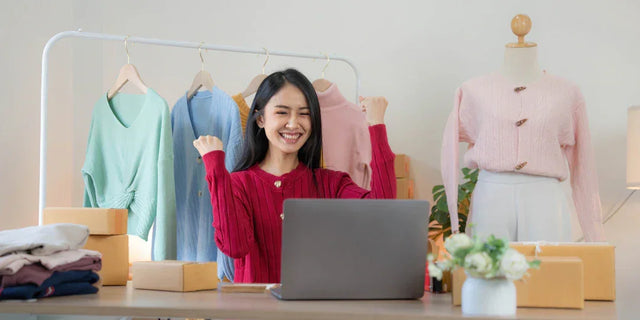 Young woman celebrating success in online clothing business, exemplifying continuous learning
