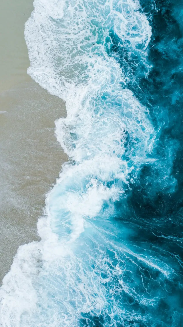 Aerial view of the ocean promoting mindfulness practices to reduce stress and enhance positive work culture.