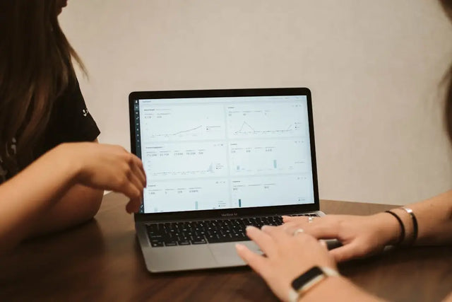 MacBook laptop with hands typing, symbolizing data-driven decision making in business.