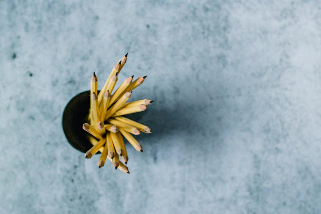 Yellow pencils in a circular pattern symbolize embracing continuous learning for leadership.