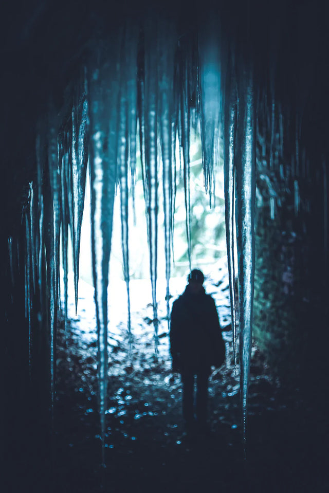 Silhouetted person framed by icicles illustrating embracing fear and resilience