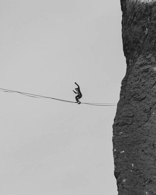 Person highlining between cliffs symbolizing emotional resilience and personal growth
