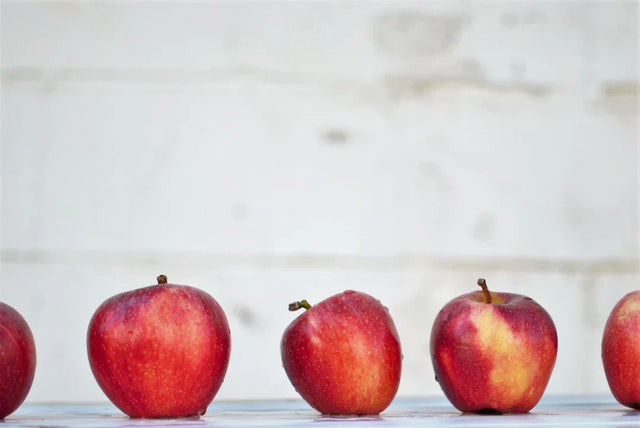 Five red apples in a row symbolizing growth in positive school culture for school leaders