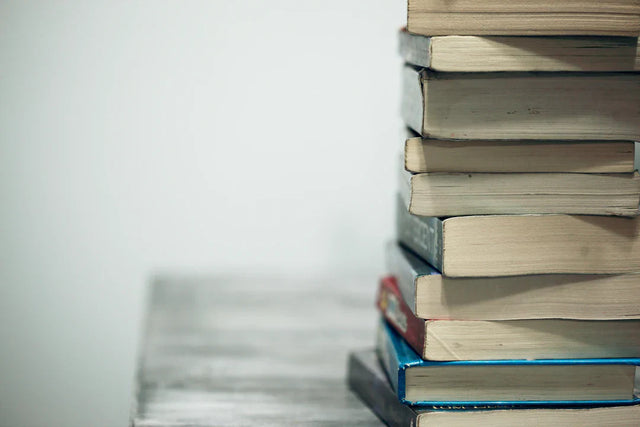 Stack of books with worn pages representing stakeholder input for enhancing school vision