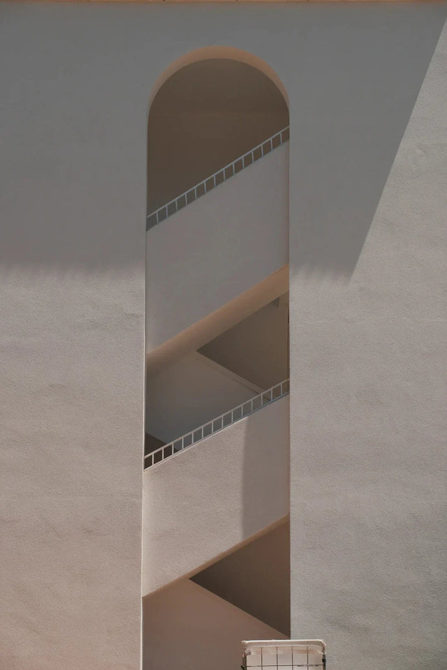Spiral staircase within narrow arch symbolizing personal growth and feeling stuck progress