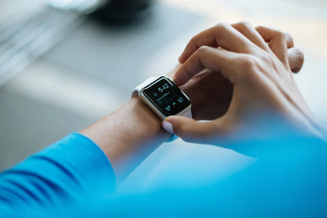 Person wearing a white smartwatch with a black screen illustrating effective time management and priority matrix concepts