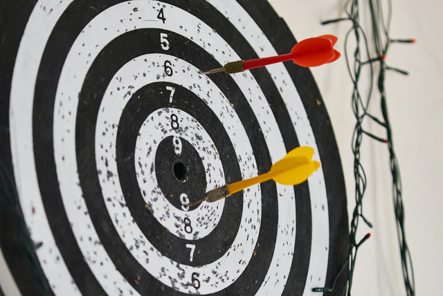 Dartboard with red and yellow darts symbolizing focus on SMART Goals and success