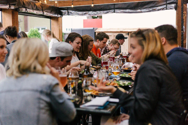 Group dining scene illustrating organizational growth and avodah dynamics in a restaurant
