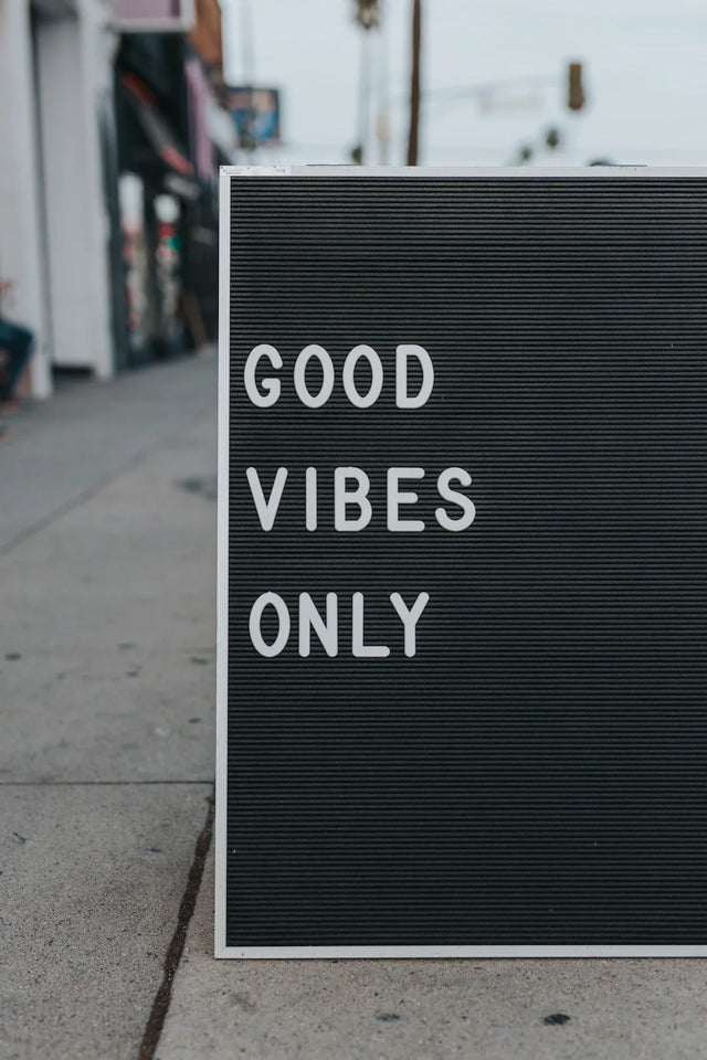 Black letter board with white frame illustrating positive influences on personal development