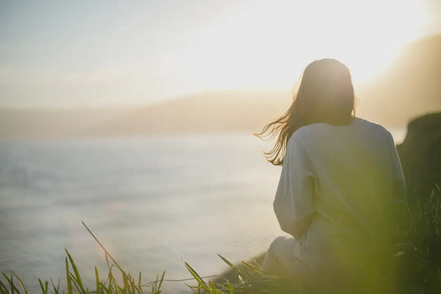 A person reflecting on nature to prevent digital burnout in a peaceful work environment.